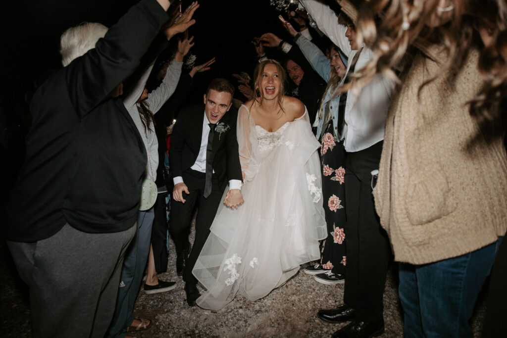 fun wedding exit photo of bride and groom