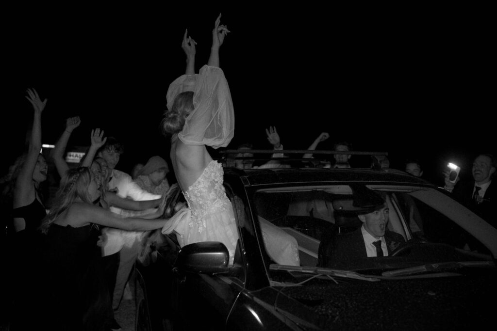 bride and groom sitting in getaway car after their wedding day