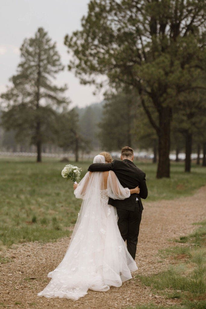 bride and groom walking together in the forest